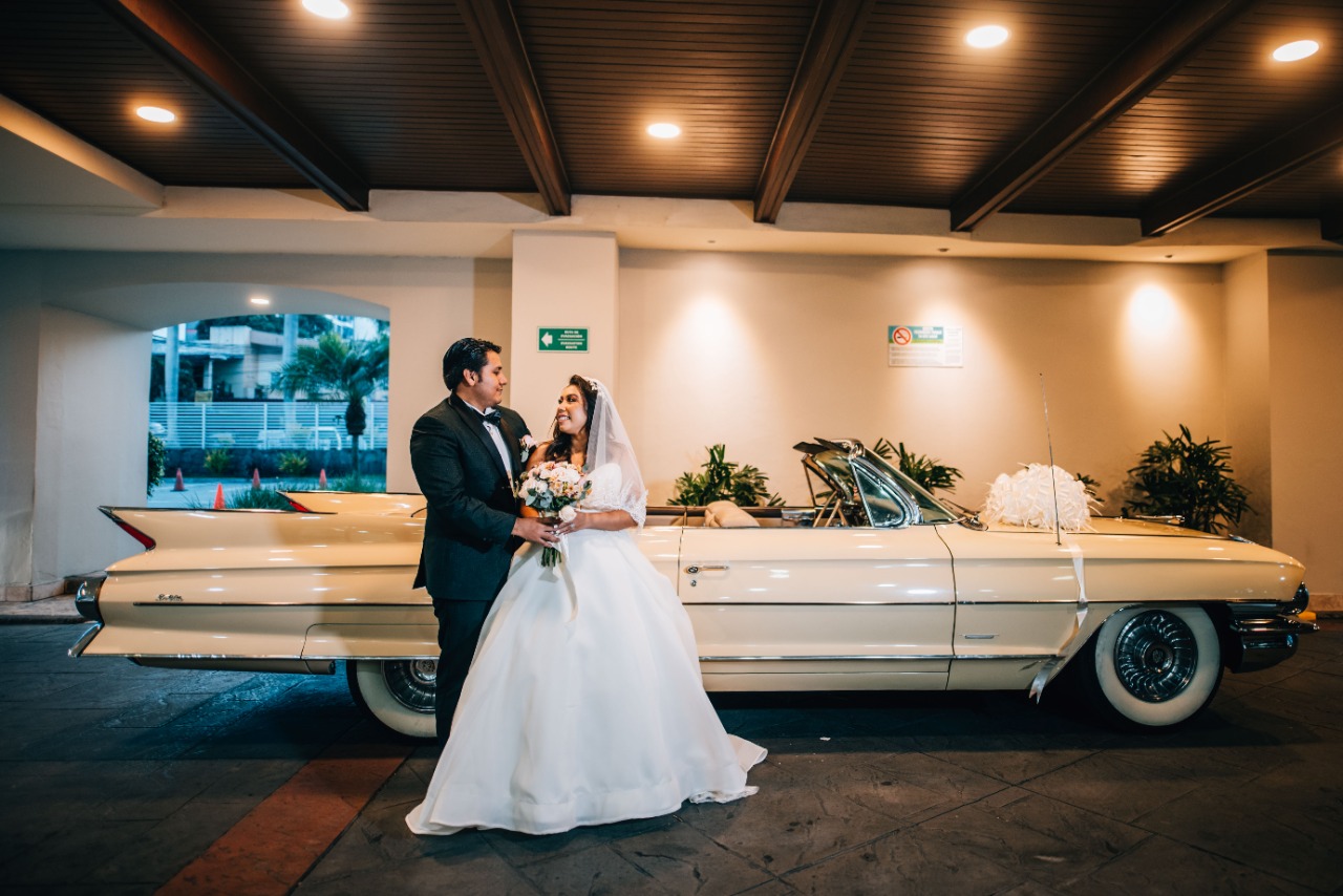 Novios junto al auto clásico